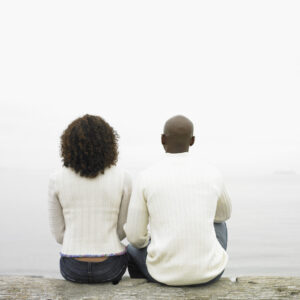 Couple sitting by lake